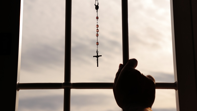 rosary hanging from the window