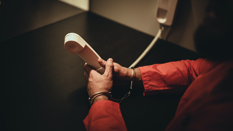 inmate holding a phone