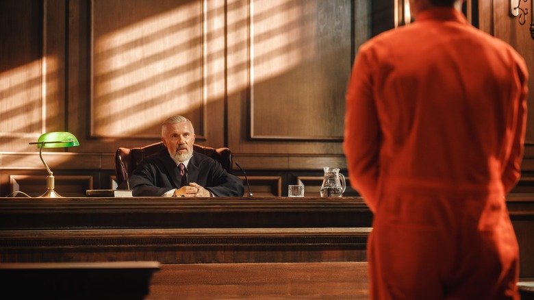 prison inmate standing in front of a judge