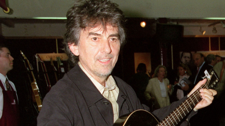George Harrison holding guitar
