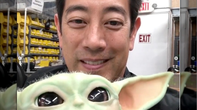 Grant Imahara holds his Baby Yoda robot