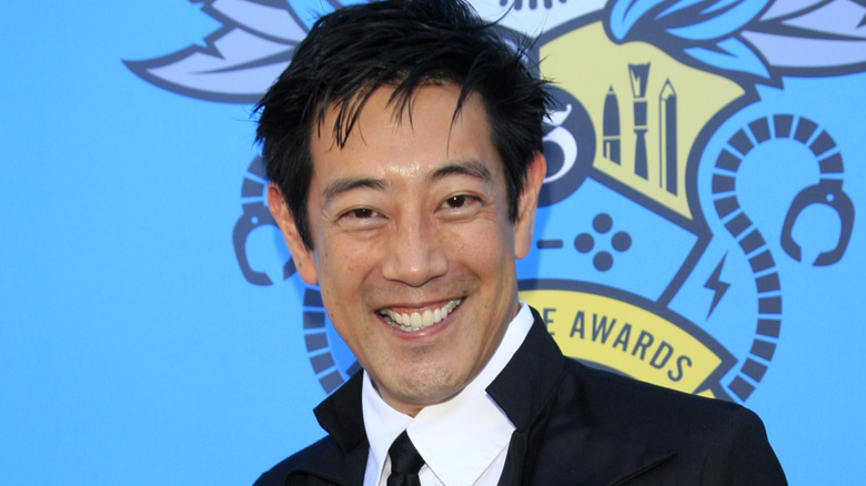 Grant Imahara smiling in white shirt and tie