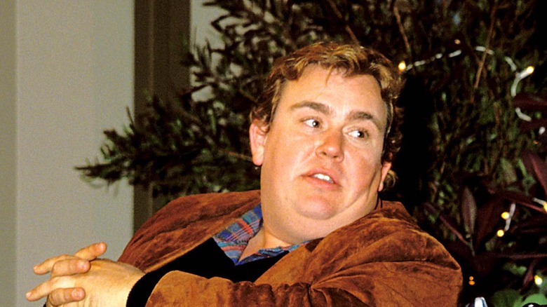 John Candy wearing a light brown jacket