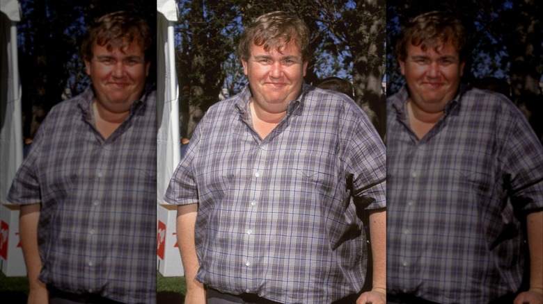 John Candy wearing a checked shirt smiling