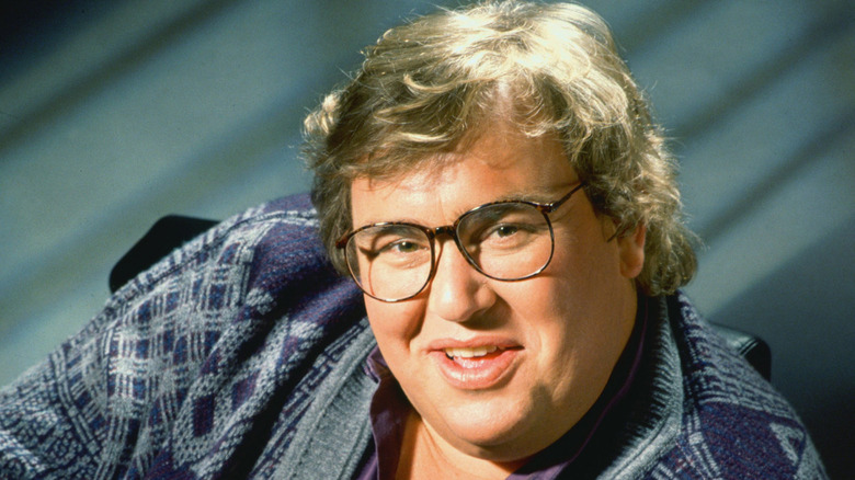 John Candy posing in sweater smiling 1993