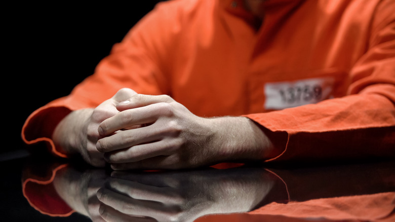 Prisoner with hands crossed