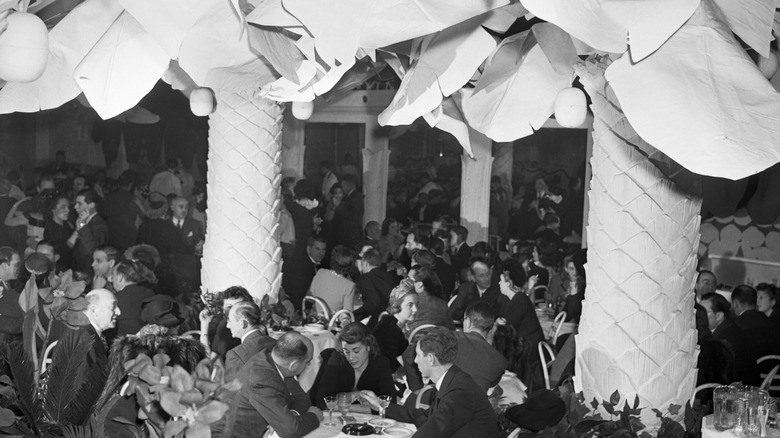 Copacabana patrons sitting benath palm trees