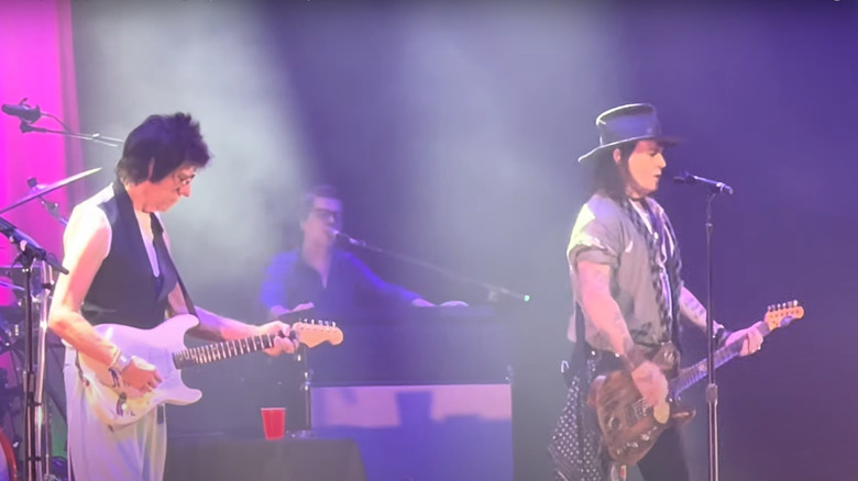 Jeff Beck and Johnny Depp perform on a colorful stage