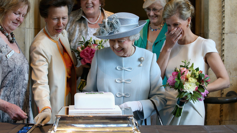 Queen Elizabeth cutting a cake