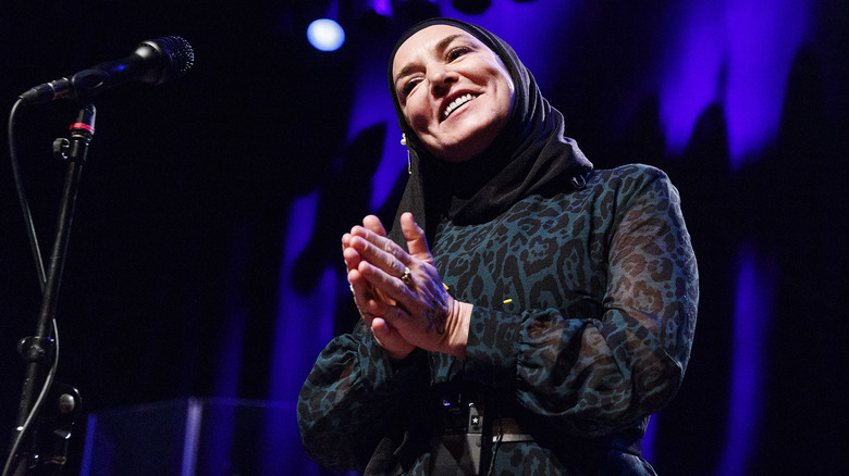 Sinead O'Connor on stage and smiling