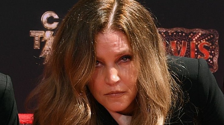 Lisa Marie Presley looking up long hair Elvis event