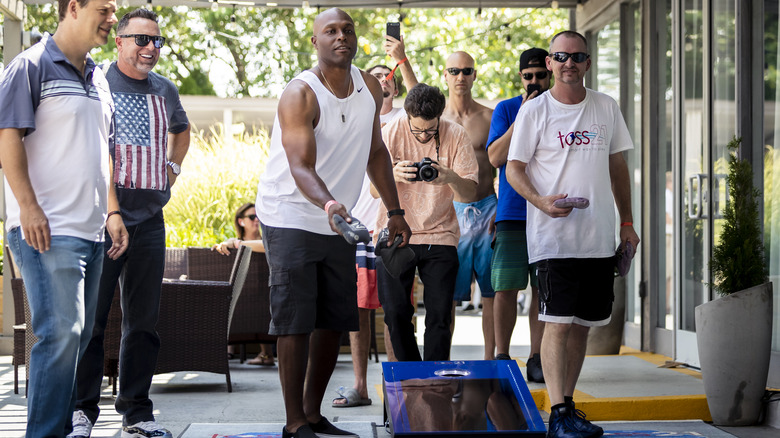 People playing cornhole