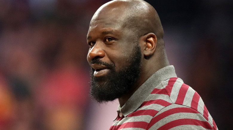 Shaquille O'Neal smiling courtside