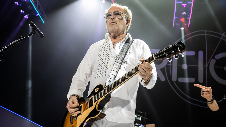 Mick Jones plays guitar during Foreigner performance