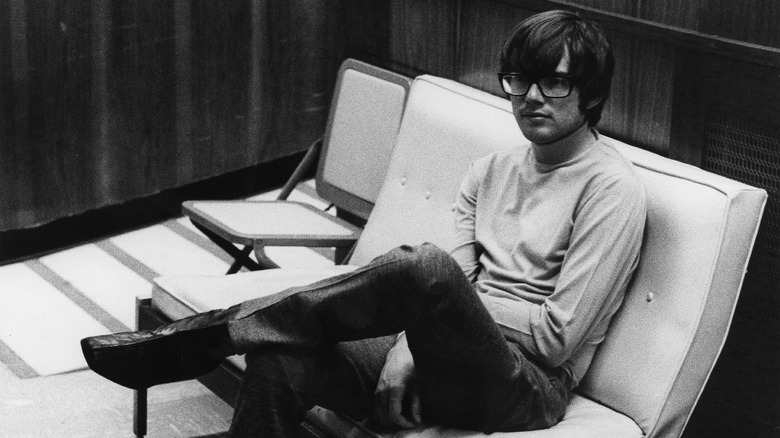 Young Jimmy Webb seated in glasses