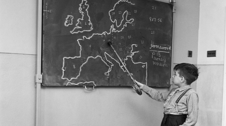 1950s schoolchild with chalkboard map of Europe