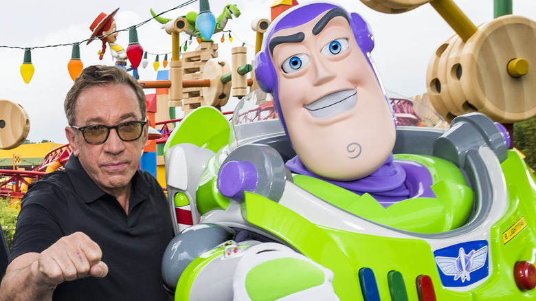 Tim Allen posing with Buzz Lightyear