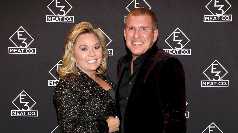 Julie and Todd Chrisley posing on red carpet