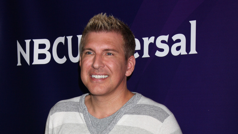 Todd Chrisley in striped shirt at event