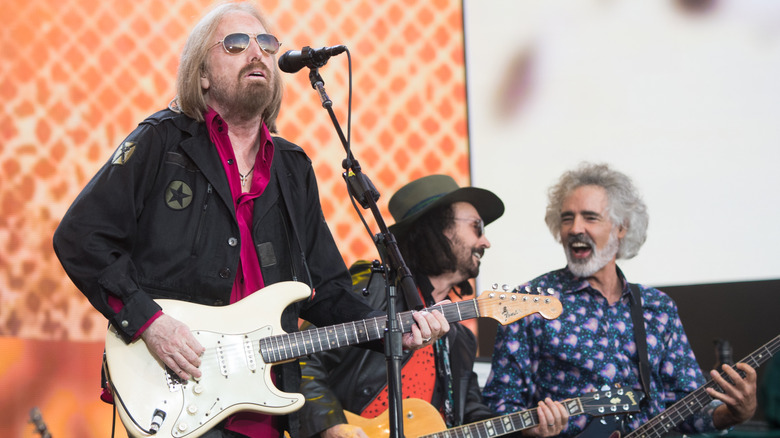 Tom Petty, Mike Campbell, and Ron Blair performing on stage together