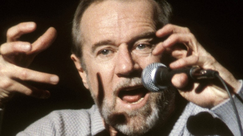 George Carlin with microphone