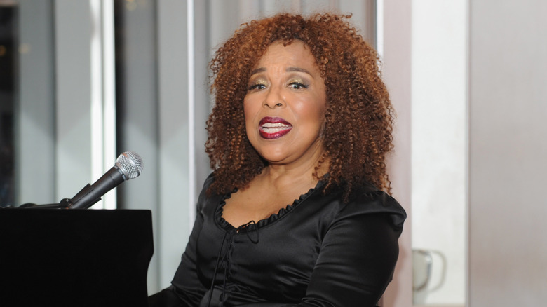 Roberta flack performing at piano with microphone