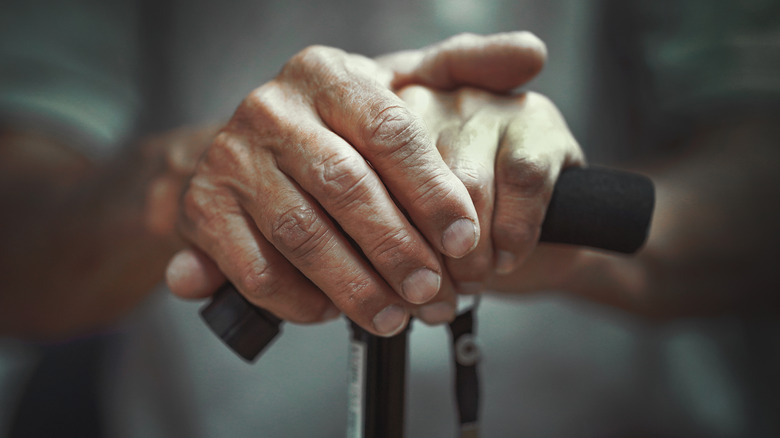 Photo of elderly hands on cane