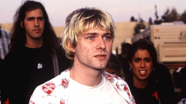 Kurt Cobain with two people in background