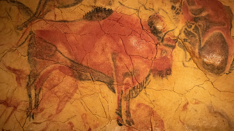 Cave art depicting a red-and-black bull