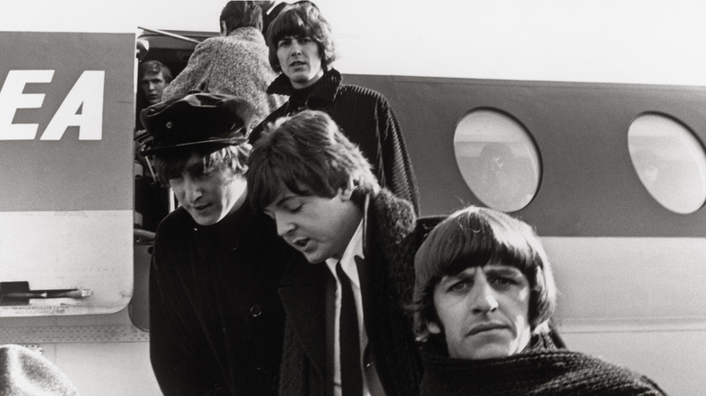 The Beatles disembarking a plane