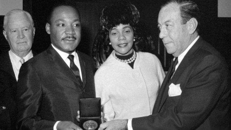 Martin Luther King Jr. smiling receiving medal