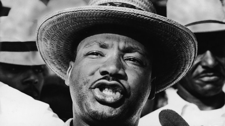 Martin Luther King Jr. in wicker hat speaking