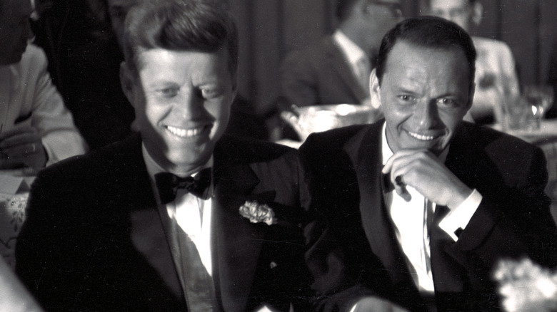 JFK and Frank Sinatra at a table