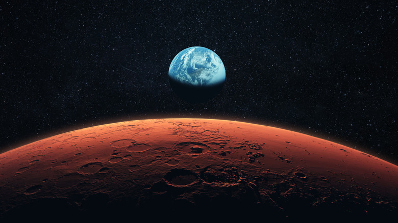 Mars in space with Earth in the background