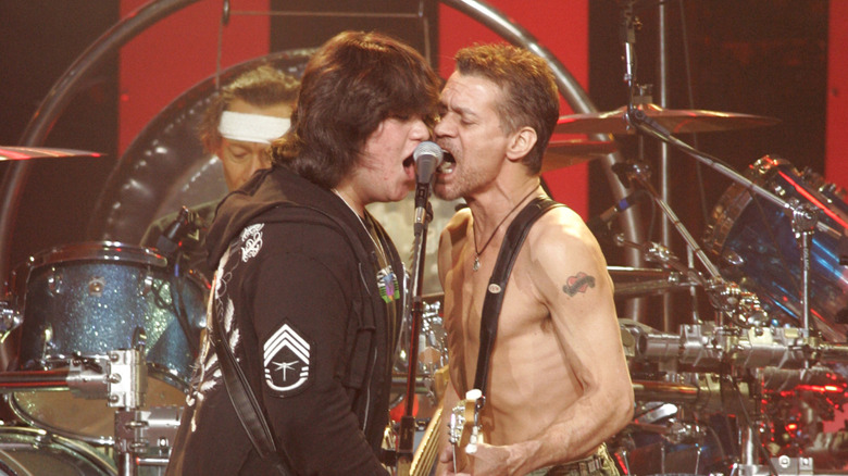 Wolfgang and Eddie Van Halen singing into a mic at the Rose Garden Arena