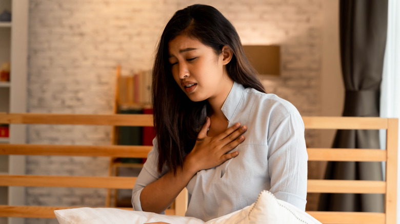 woman holding her chest