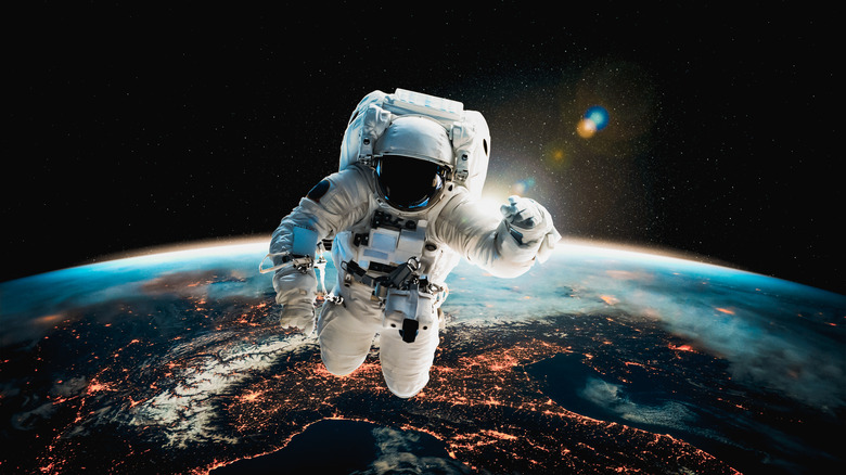 astronaut floating above Earth