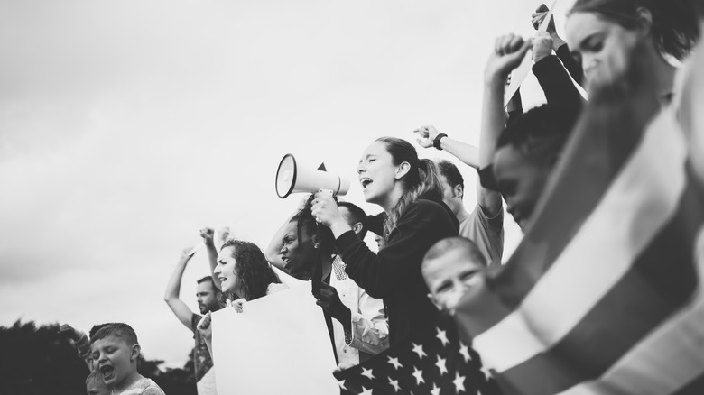 People behind American flag protesting