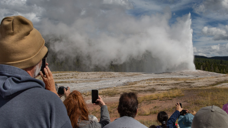 Tourists view geyser