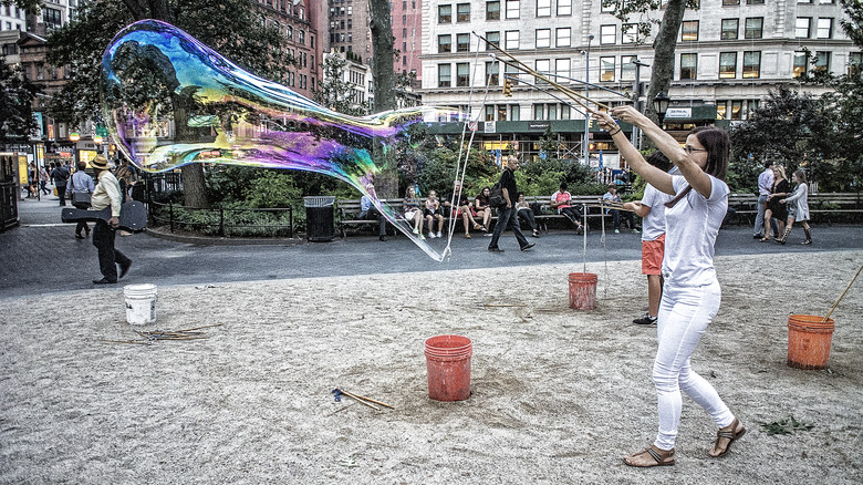 Woman making bubble in Madison Park