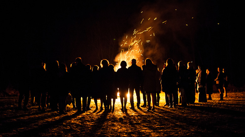 people around bonfire at night