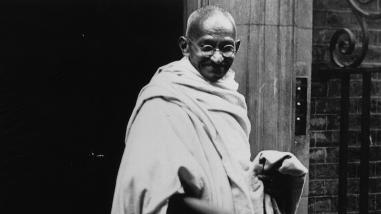 Mahatma Gandhi in white smiling