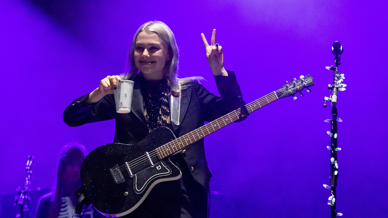 Phoebe Bridgers playing guitar