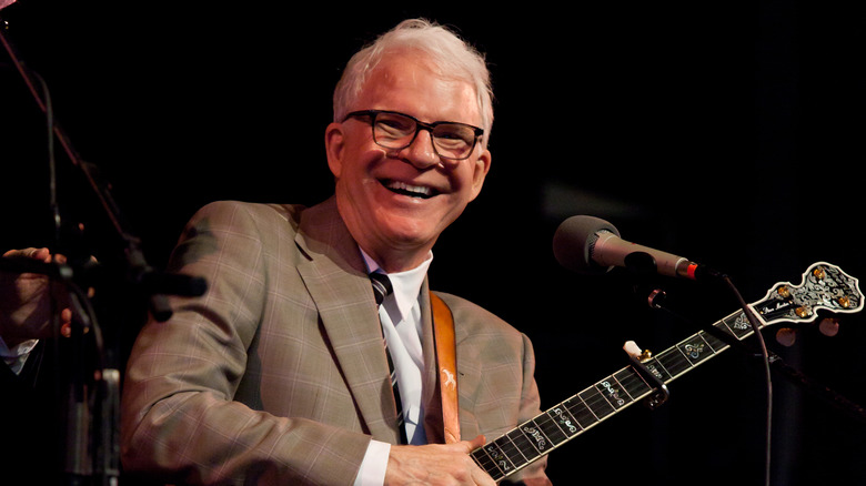 steve martin holding a banjo