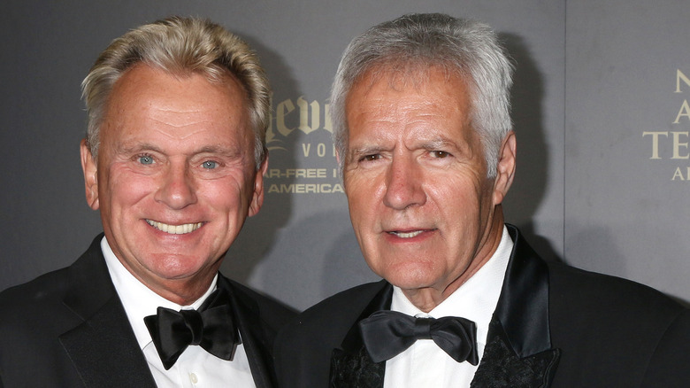 Pat Sajak smiles with Alex Trebek