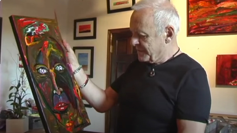 Anthony Hopkins holding a painting