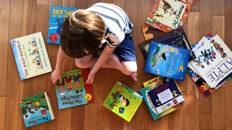 Child surrounded by books