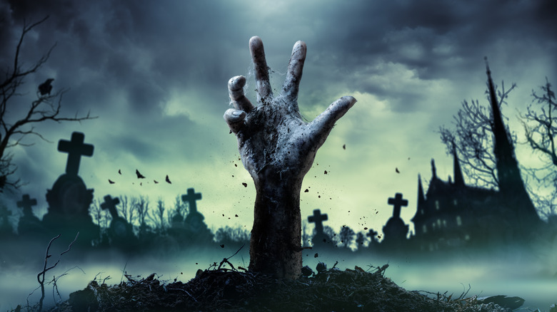 Zombie hand coming out of grave