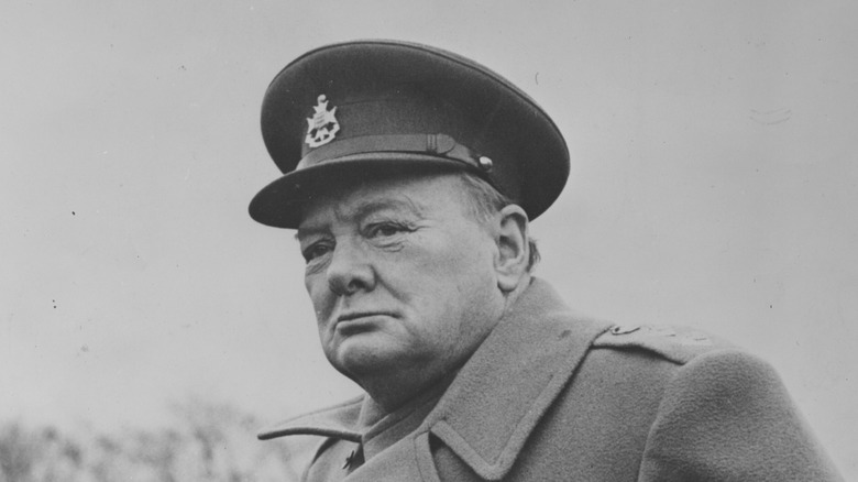 Winston Churchill in military-style hat, looking into middle distance