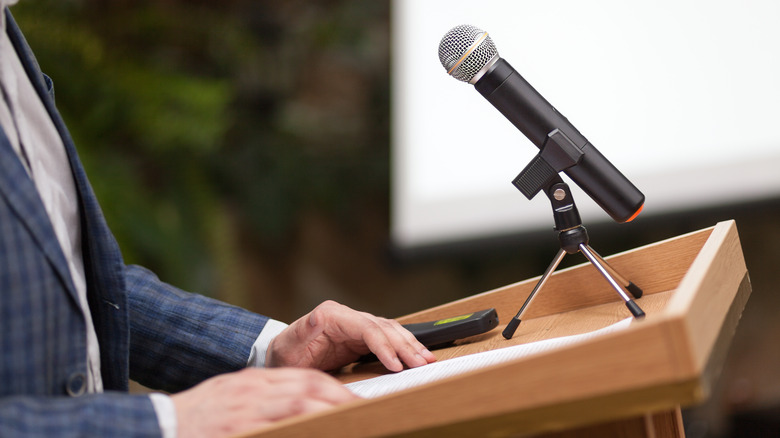 man speaking at podium